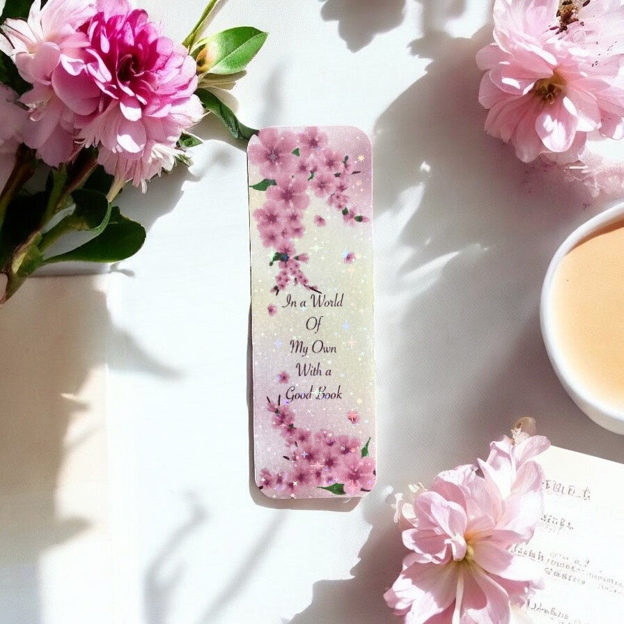 Elegant pink blossom bookmark with holographic sparkle finish, featuring delicate floral design perfect for book lovers and gift giving"