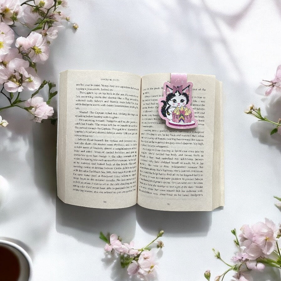 Magnetic kitten bookmark with cake design showing holographic sparkle details, ideal for marking book pages"