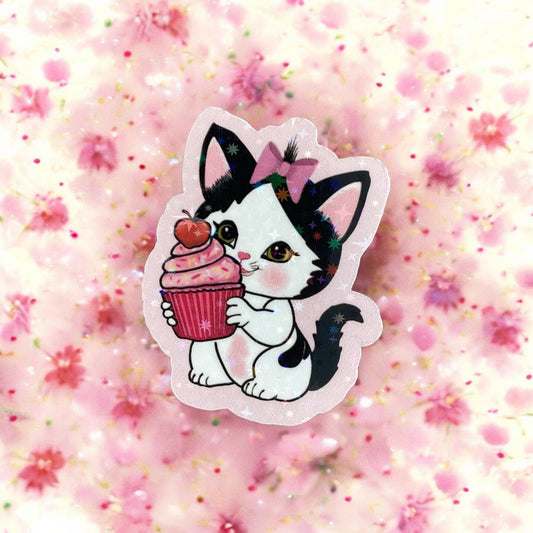 "Kitten with cupcake die-cut sticker applied to surface - showing size and vibrant colors"