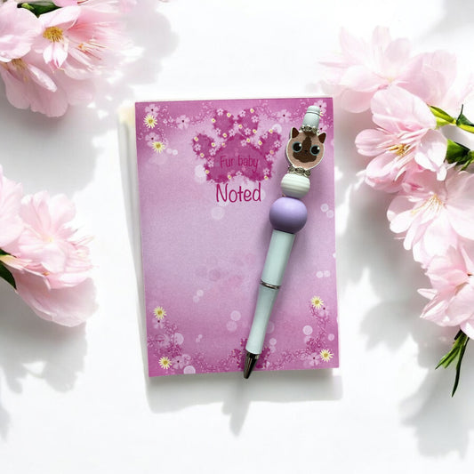 Lilac and white decorative beads adorning elegant cat-themed pen"