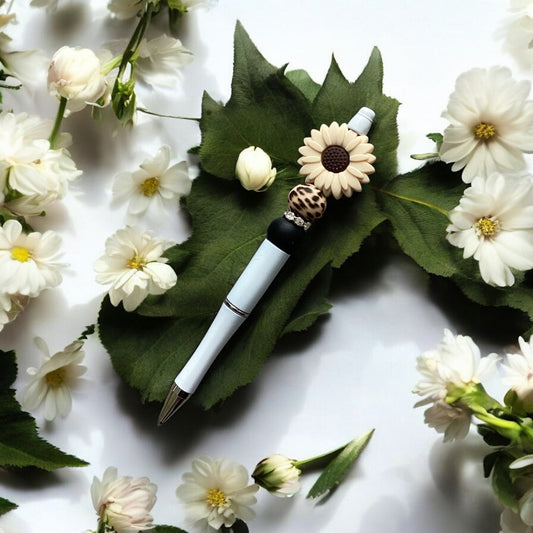 "Cream daisy beaded pen with leopard print pattern in white casing"